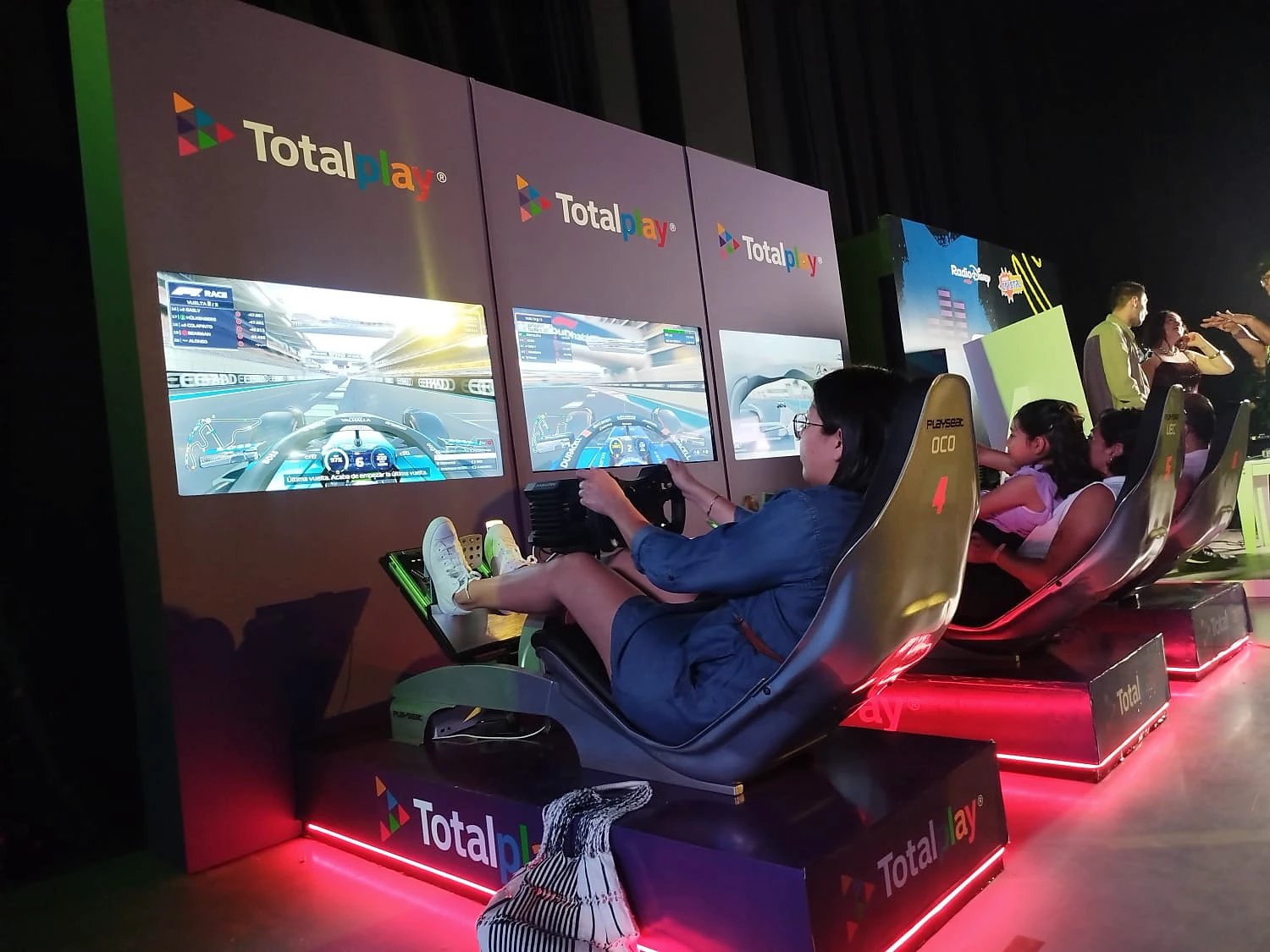 Totalplay: Postura de monoplaza y tarimas iluminadas para participar y competir.
